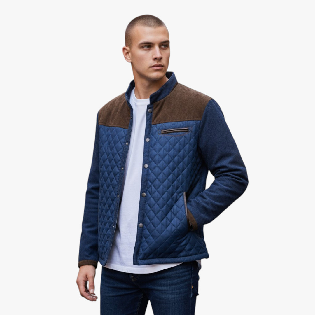 Man wearing a blue and brown quilted jacket on a white background