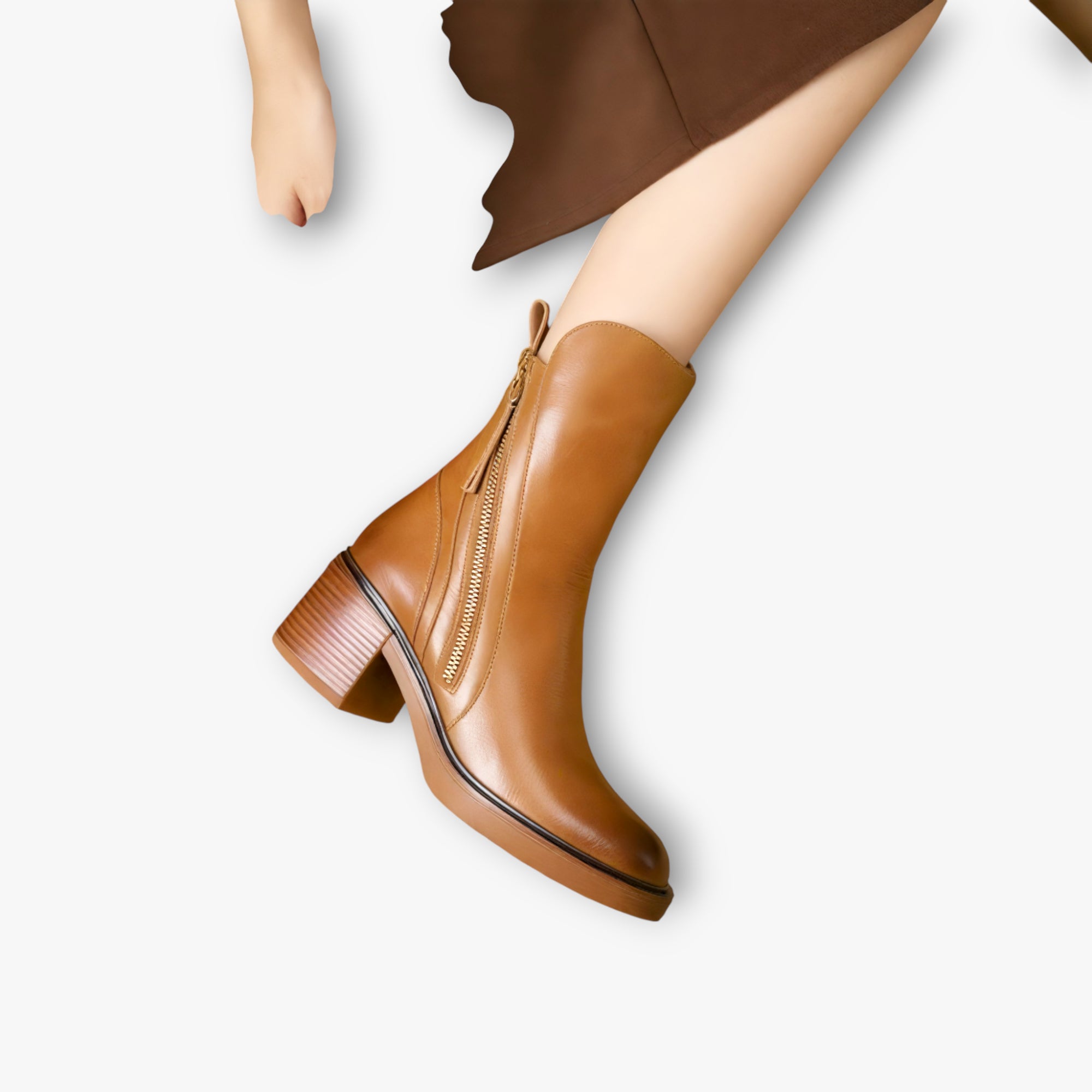 Brown ankle boot worn by a person on a white background