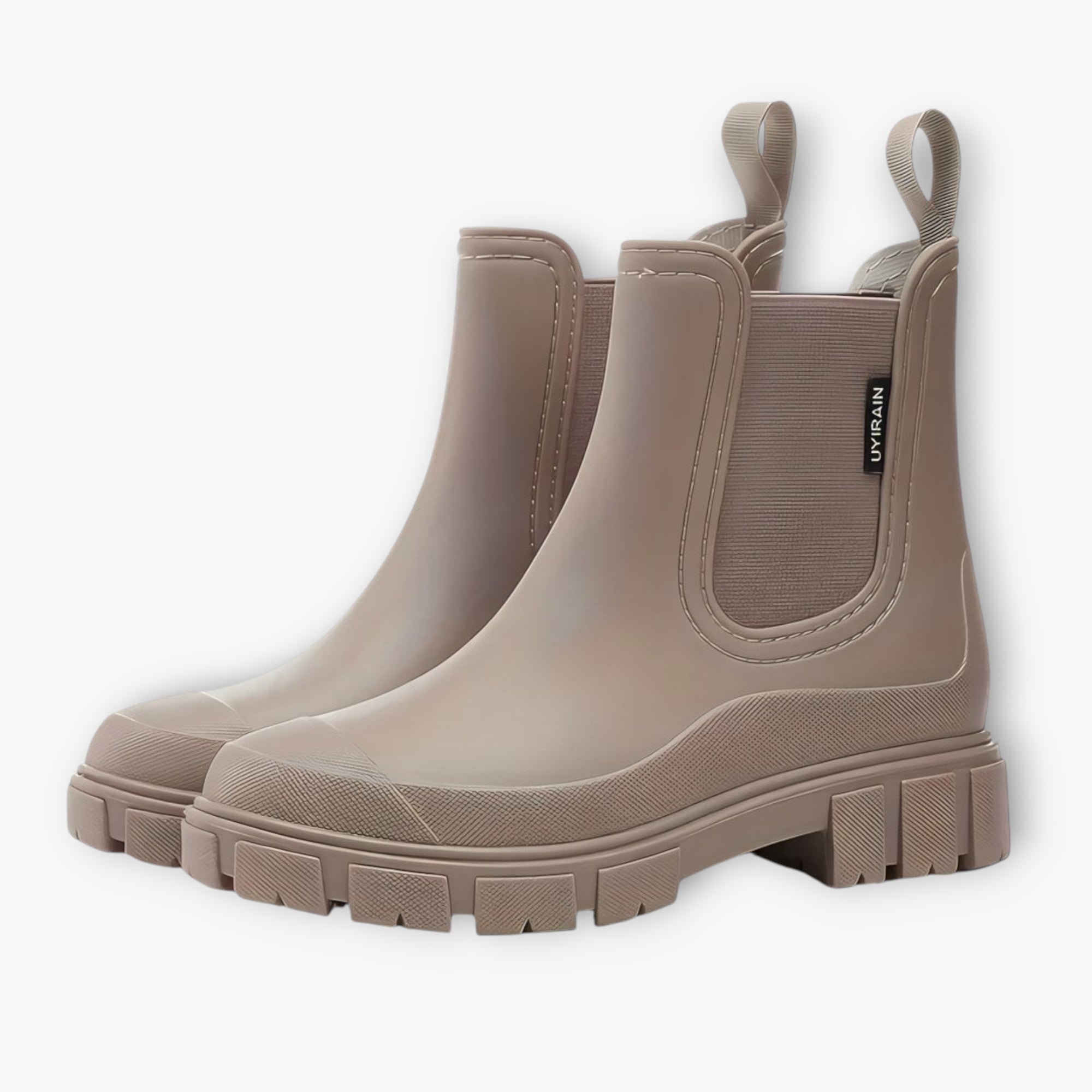Pair of beige rubber boots on a white background