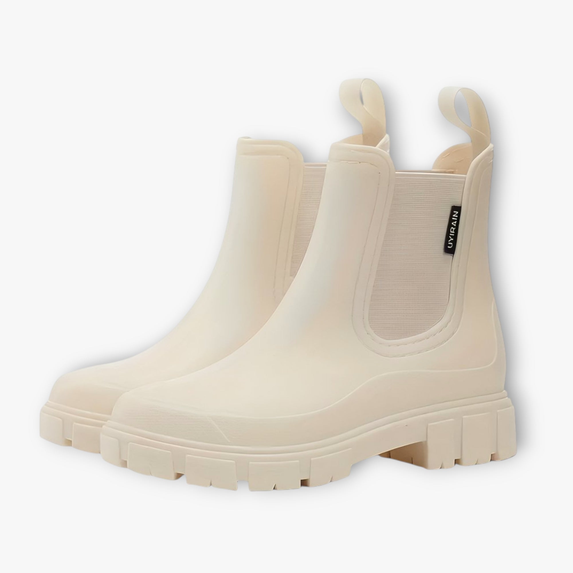 Pair of beige rain boots on a white background