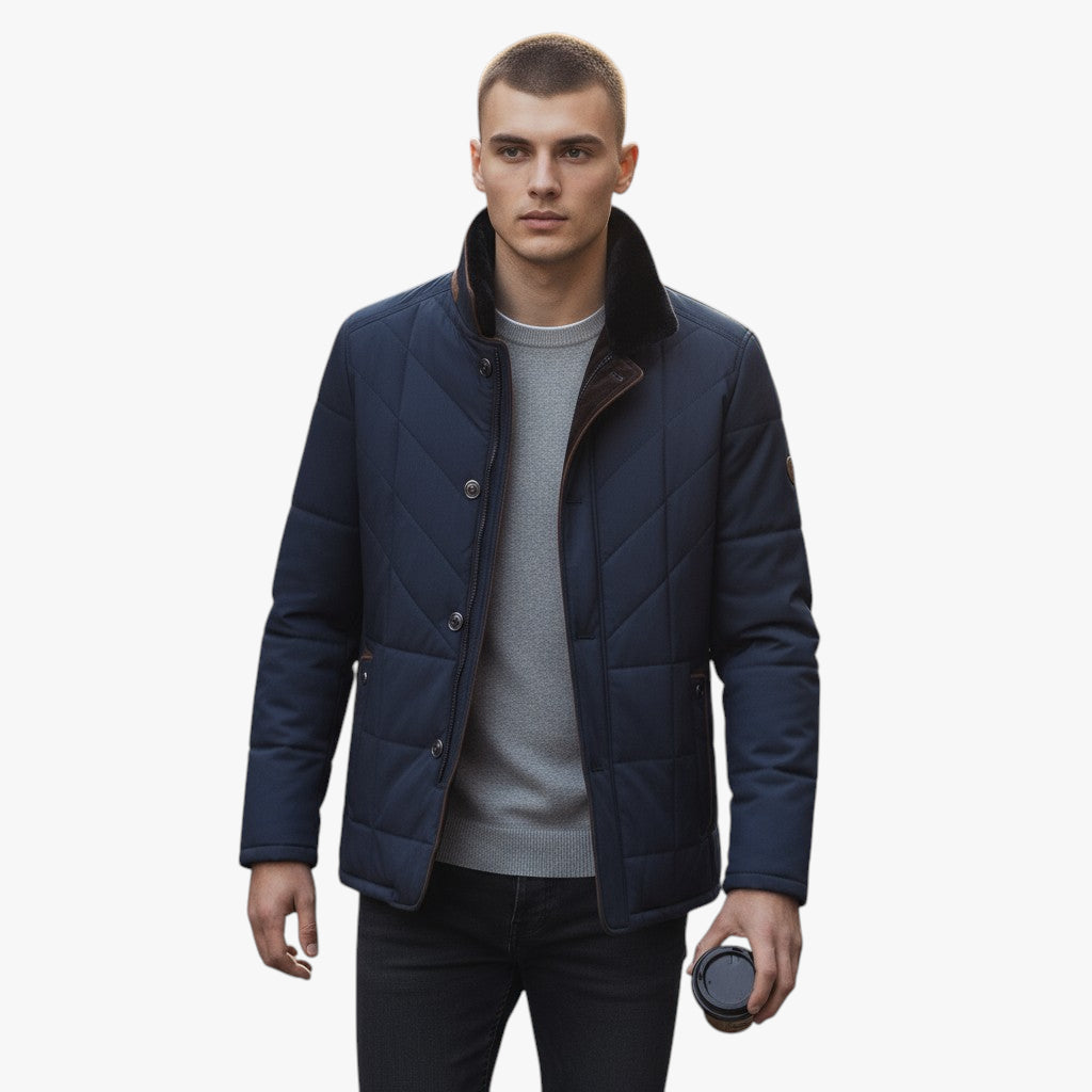 Man wearing a navy blue quilted jacket on a white background