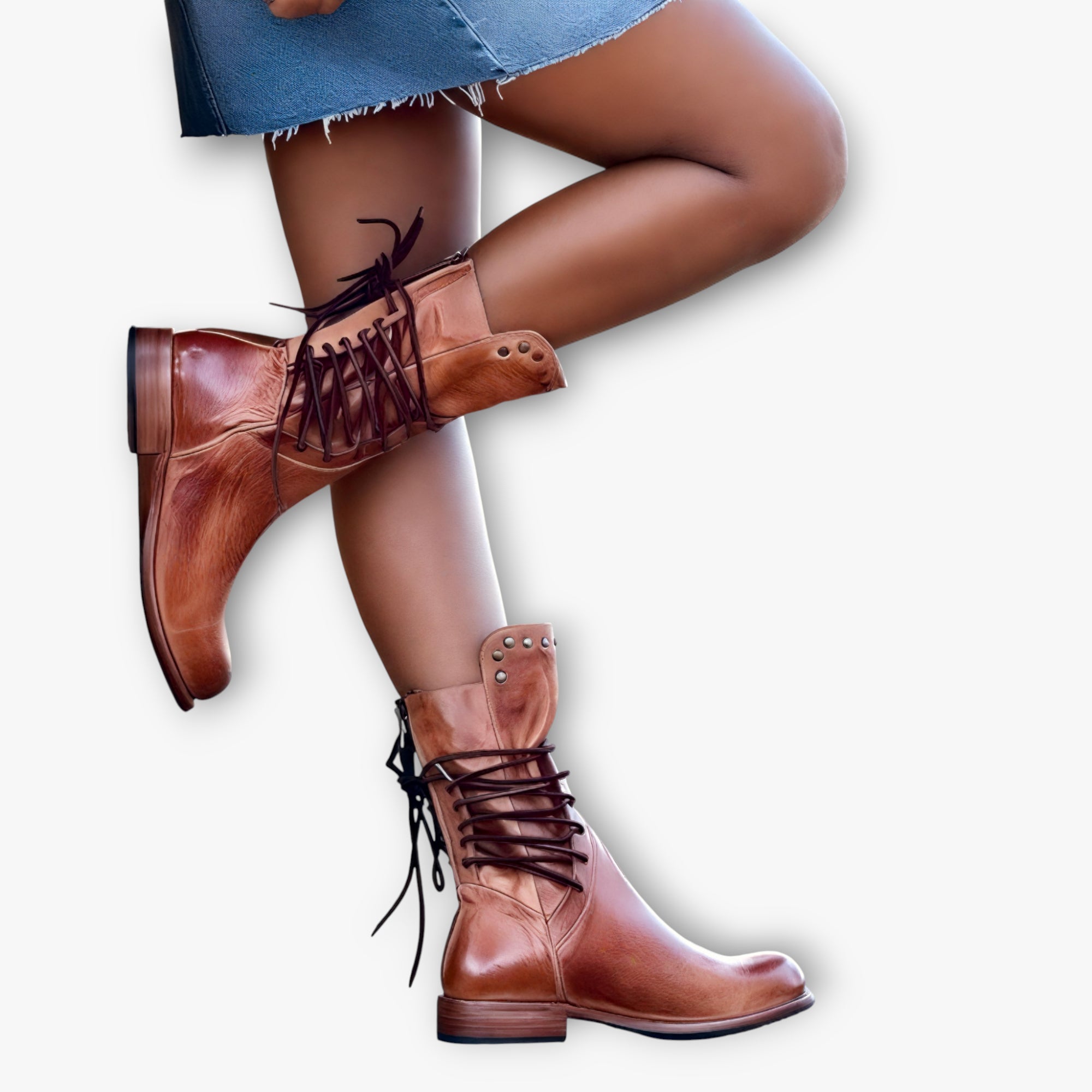 Brown leather boots with lace-up design worn by a person on a white background
