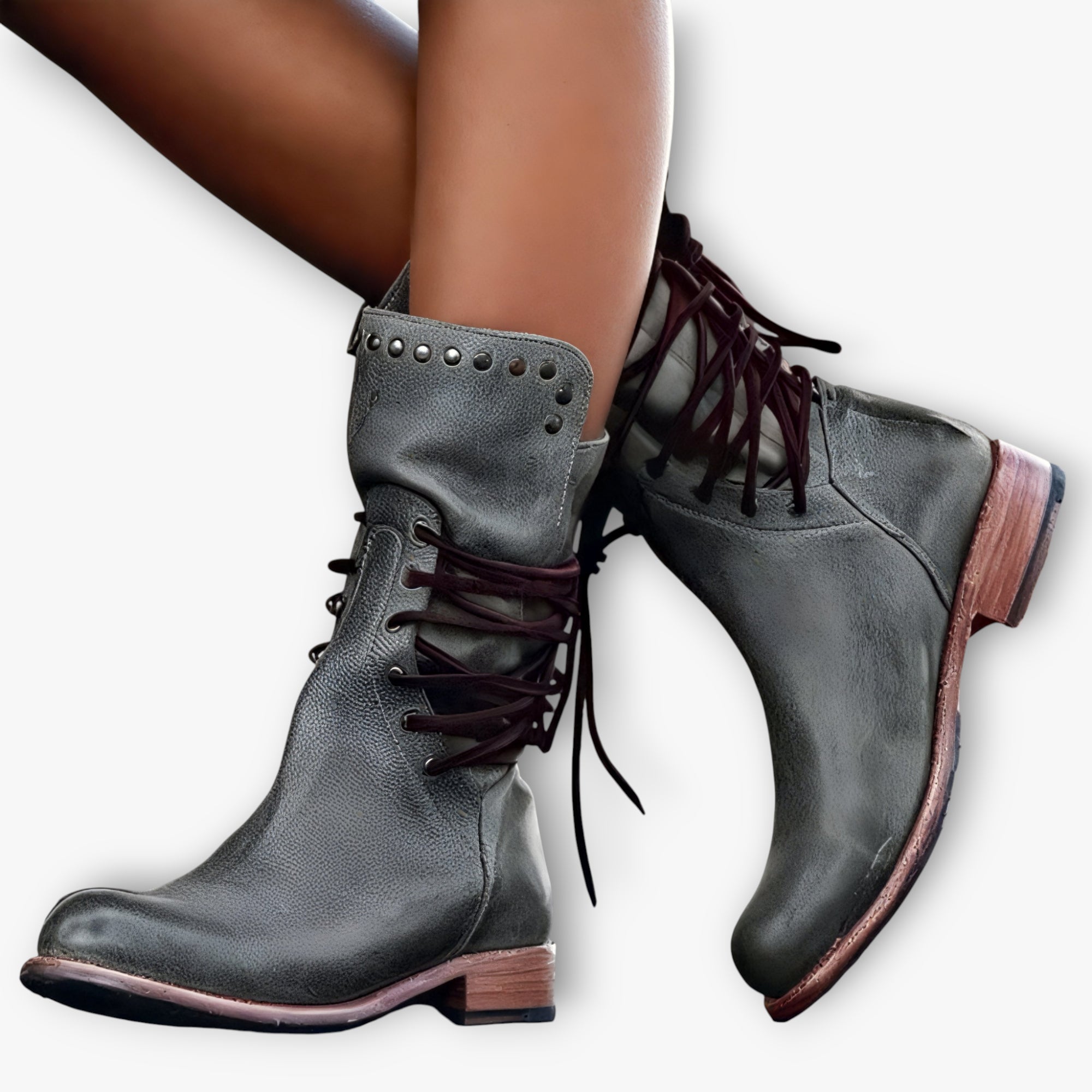 Gray leather boots with brown soles worn by a person on a white background