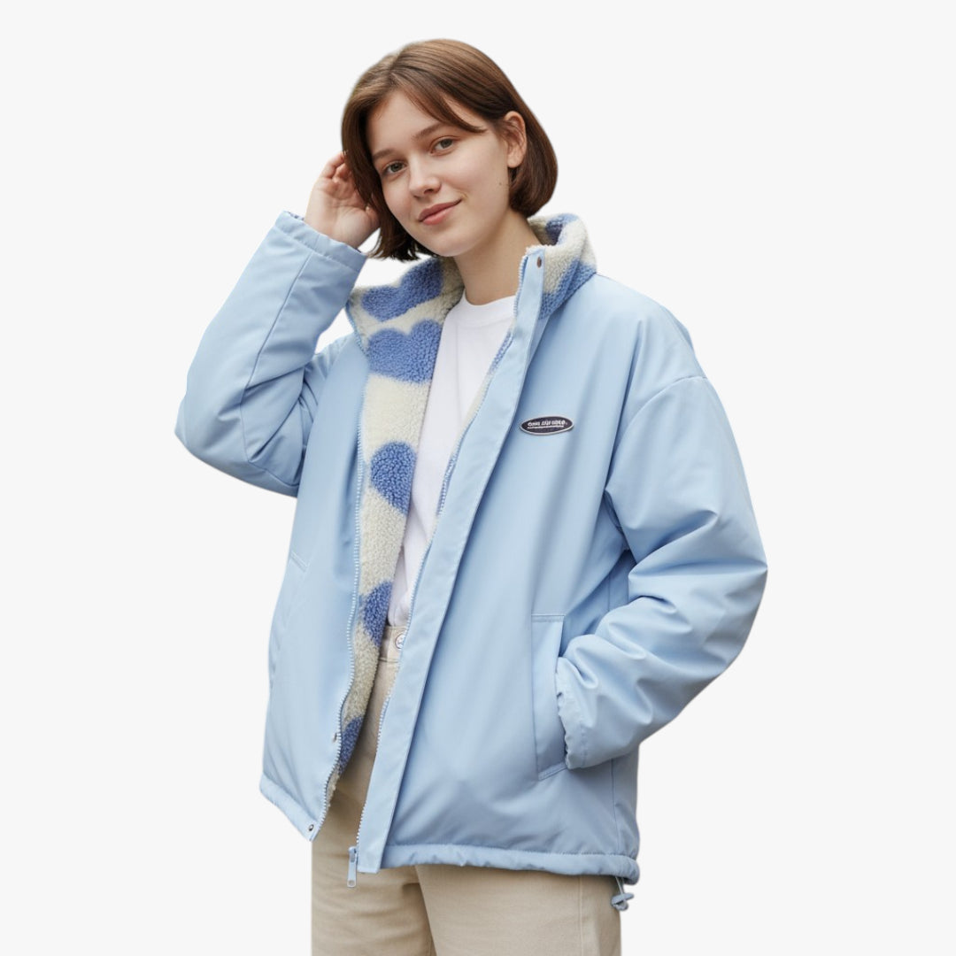 Woman wearing a light blue jacket with a hood on a white background