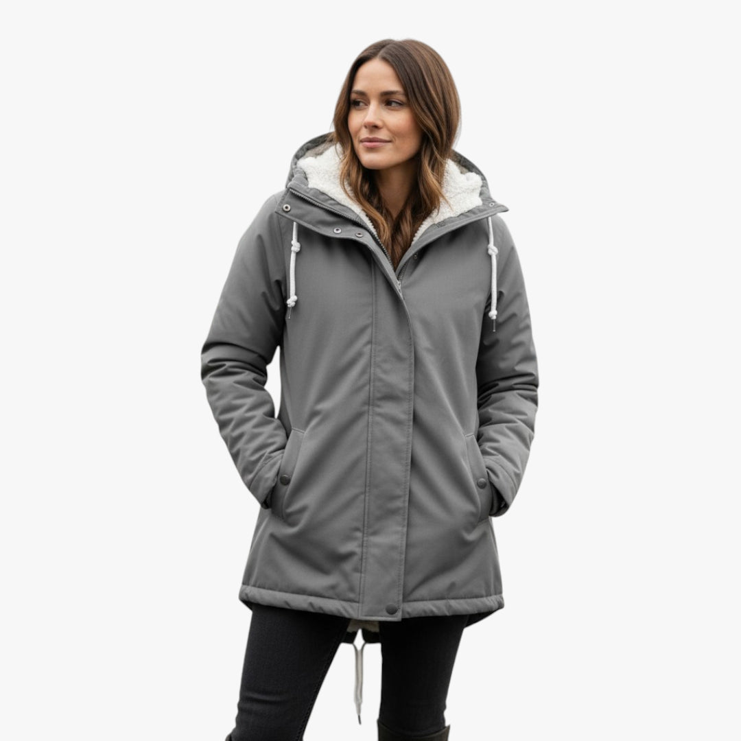 Woman wearing a gray parka with white lining on a white background